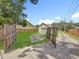 Long driveway featuring a sturdy fence gate, leading to a detached garage and parking area at 3327 25Th N St, St Petersburg, FL 33713