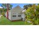 Charming home with vinyl siding, brick chimney, and tropical plants in the front yard at 3327 25Th N St, St Petersburg, FL 33713