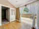 Hallway entrance to a wood deck with a glass door and white curtains at 3327 25Th N St, St Petersburg, FL 33713