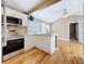 A well-lit kitchen features white cabinetry, stainless steel appliances, and an eat-in counter at 3327 25Th N St, St Petersburg, FL 33713
