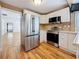 Bright kitchen featuring stainless steel refrigerator, range, and microwave, with white cabinets at 3327 25Th N St, St Petersburg, FL 33713