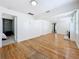 Spacious living room featuring hardwood floors, neutral walls, and doorway leading into the primary bedroom at 3327 25Th N St, St Petersburg, FL 33713