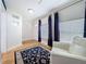 Bright living room with hardwood floors, white walls, large windows, and a comfortable white chair at 3327 25Th N St, St Petersburg, FL 33713