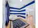 Stylish living room featuring a white leather chair, blue striped walls, and hardwood floors at 3327 25Th N St, St Petersburg, FL 33713