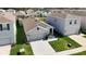 Aerial view showcasing this well-kept gray home, neighboring properties, and lush green lawns in a tidy neighborhood at 34033 Jasper Stone Dr, Wesley Chapel, FL 33543