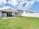 A spacious backyard featuring a covered patio, a storage shed and a hammock at 34033 Jasper Stone Dr, Wesley Chapel, FL 33543