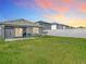 Large backyard featuring a hammock, covered patio, and vinyl fence at 34033 Jasper Stone Dr, Wesley Chapel, FL 33543