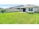 Large backyard featuring a hammock, covered patio, and vinyl fence at 34033 Jasper Stone Dr, Wesley Chapel, FL 33543