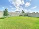 Large backyard featuring a vinyl fence and garden at 34033 Jasper Stone Dr, Wesley Chapel, FL 33543