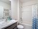 Well-lit bathroom with a combination tub and shower, featuring tiled walls and modern fixtures at 34033 Jasper Stone Dr, Wesley Chapel, FL 33543