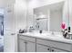 The light-filled bathroom features double sinks, a large mirror, and access to a walk-in shower at 34033 Jasper Stone Dr, Wesley Chapel, FL 33543