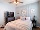 Charming bedroom featuring decorative wall panels, a cozy bed, and stylish furnishings at 34033 Jasper Stone Dr, Wesley Chapel, FL 33543