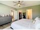 Bedroom featuring access to a sitting room, walk-in closet, and an en-suite bathroom at 34033 Jasper Stone Dr, Wesley Chapel, FL 33543