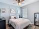 Stylish bedroom with elegant wall paneling, a cozy bed, and decorative artwork at 34033 Jasper Stone Dr, Wesley Chapel, FL 33543