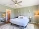 Bedroom featuring panel accent wall, ceiling fan, and access to the glass-enclosed walk-in shower at 34033 Jasper Stone Dr, Wesley Chapel, FL 33543