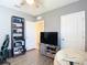 Bedroom showcasing a bookshelf, TV, and comfortable beanbag, perfect for relaxation at 34033 Jasper Stone Dr, Wesley Chapel, FL 33543