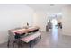 Bright dining area featuring modern table and seating, with views to the living room and kitchen at 34033 Jasper Stone Dr, Wesley Chapel, FL 33543