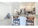 Kitchen island featuring stone countertops and a breakfast bar with views to the fridge at 34033 Jasper Stone Dr, Wesley Chapel, FL 33543
