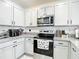 A crisp and well-lit kitchen featuring stainless steel appliances and stone countertops at 34033 Jasper Stone Dr, Wesley Chapel, FL 33543