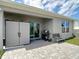 Covered patio boasts a storage shed, BBQ grill, and chair at 34033 Jasper Stone Dr, Wesley Chapel, FL 33543