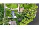Aerial view of property showing meticulous landscaping, multiple structures and lake access at 3620 Little Rd, Lutz, FL 33548