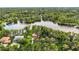 Aerial view of a home and surrounding landscape with lake and trees at 3620 Little Rd, Lutz, FL 33548