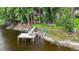 Stunning aerial view of the property, featuring a dock, lush greenery, and waterfront access at 3620 Little Rd, Lutz, FL 33548