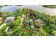 Aerial view of lakeside home with defined property lines and mature landscaping at 3620 Little Rd, Lutz, FL 33548