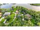 Expansive aerial view showcases lush landscaping and lakefront property at 3620 Little Rd, Lutz, FL 33548
