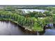 Beautiful aerial showing waterfront living nestled among mature trees at 3620 Little Rd, Lutz, FL 33548