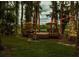 Secluded backyard deck amid mature trees and string lights, perfect for dining at 3620 Little Rd, Lutz, FL 33548