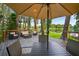 Relaxing backyard deck featuring comfortable seating, a table, and lovely lake views at 3620 Little Rd, Lutz, FL 33548