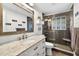 Bathroom featuring white vanity with a marble countertop and a glass-enclosed shower at 3620 Little Rd, Lutz, FL 33548