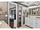 Bright en-suite bathroom with double vanity, tile floor, and glass enclosed shower at 3620 Little Rd, Lutz, FL 33548