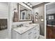 Bathroom featuring white cabinets, double sinks, mirrors, and decorative fixtures at 3620 Little Rd, Lutz, FL 33548