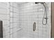 Modern bathroom with sleek white subway tile, glass shower door, and convenient shower seat at 3620 Little Rd, Lutz, FL 33548