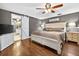 Comfortable bedroom with a ceiling fan and barn door to the en-suite bathroom at 3620 Little Rd, Lutz, FL 33548