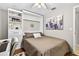 Bedroom with murphy bed, ceiling fan, built-in shelves, and lots of natural light at 3620 Little Rd, Lutz, FL 33548