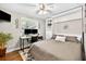 Bedroom with murphy bed, ceiling fan, built-in shelves, and lots of natural light at 3620 Little Rd, Lutz, FL 33548