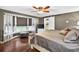 Comfortable bedroom with a ceiling fan and barn door to the en-suite bathroom at 3620 Little Rd, Lutz, FL 33548
