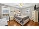 Cozy bedroom with a panel headboard, built in drawers, and ample natural light at 3620 Little Rd, Lutz, FL 33548