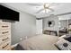 Neutral bedroom with wood accents, great natural light, and a large mounted television at 3620 Little Rd, Lutz, FL 33548