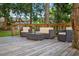 A comfortable seating arrangement on a wooden deck offers an inviting outdoor space for relaxation and entertainment at 3620 Little Rd, Lutz, FL 33548