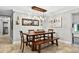 Elegant dining room featuring a wooden table with a bench and eye-catching modern chandelier at 3620 Little Rd, Lutz, FL 33548