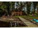 Picturesque backyard featuring a private dock, string-lit deck, and kayaks, ideal for lakeside living at 3620 Little Rd, Lutz, FL 33548