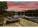Wooden dock on a lake with lounge chairs and a swim ladder at 3620 Little Rd, Lutz, FL 33548
