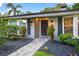Charming home featuring manicured landscaping, a stone walkway, and stylish outdoor lighting enhancing the curb appeal at 3620 Little Rd, Lutz, FL 33548