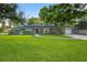 Charming one story home with mature trees and a lush green lawn at 3620 Little Rd, Lutz, FL 33548