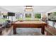Game room with a pool table, large windows, and backyard views at 3620 Little Rd, Lutz, FL 33548