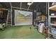 Unique golf simulator room with projection screen and ample practice space at 3620 Little Rd, Lutz, FL 33548